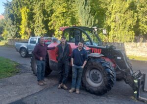 D Goadby team standing next to Manitou Telehandler